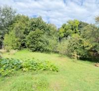 The garden of a family house in Krivosúd-Bodovka, surrounded by greenery and trees.