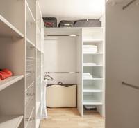 A wardrobe with shelves and a wooden decor floor in a 3-room apartment.