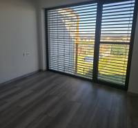 Interior in a family house with large windows and a wooden decor floor.