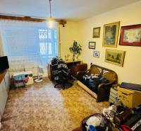 Living room in a 3-room apartment with decorations, furniture, and a wooden decor floor.