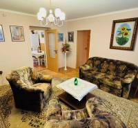 Living room with armchairs, a sofa, and a carpet in a 3-room apartment.