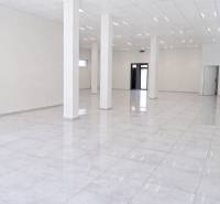 Spacious commercial spaces with white flooring and columns, ideal for business.