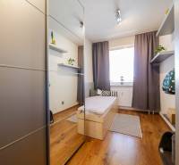 Children's room in a three-room apartment with a wooden decor floor and a built-in wardrobe.