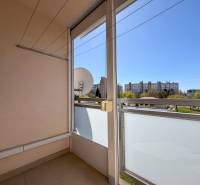 A balcony in a 3-room apartment with a view of greenery and buildings in Nitra on Murániho.