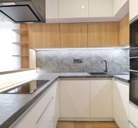 A kitchen with sleek lines and a wooden decor floor in a 3-room apartment.