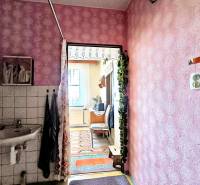 A hallway with pink walls, a sink, and a view into a room, 3-room apartment.
