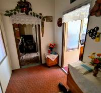 Entrance hall in a 3-room apartment with decorations and flowers on the table.