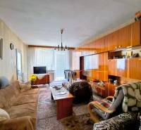 Living room in a 3-room apartment with a wooden decor floor and a sofa set.