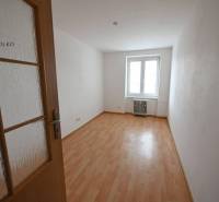 A room with a wooden decor floor in a 2-room apartment, bright room.