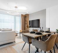Living area with a dining table and a wooden decor floor in a 3-room apartment.