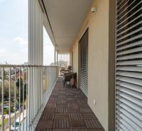 A balcony with a wooden decor floor in a 3-room apartment, view of Bratislava - Ružinov.