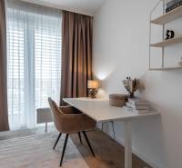 A workspace with a desk, a comfortable chair, and a shelf in a 3-room apartment.