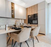 A stylish kitchen in a 3-room apartment with a dining table and a wooden decor floor.
