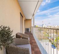 Balcony in a 3-room apartment with a wooden decor floor, view of Bratislava - Ružinov.