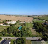 Hosťová offers expansive residential plots surrounded by nature and fields.