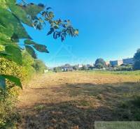 A peaceful green plot for living in Hosťová surrounded by nature and neighboring houses.