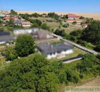 Panoramic view of plots - housing in the village of Hosťová surrounded by greenery and houses.