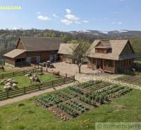 A rural estate with farm animals and a garden in a beautiful landscape near Krupina.