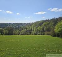 Spring landscape around Krupina, plots - housing, green meadows and forests on the horizon.