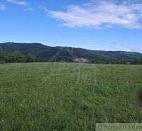 Beautiful green residential plots in Horný Tisovník with a panorama of the forest and blue sky.