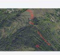 Aerial view of parceled plots for housing in Horný Tisovník with a forested landscape.