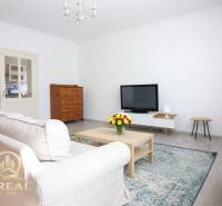 Living room with a TV, sofa, and coffee table in a studio apartment.