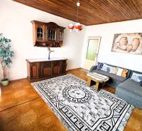 Living room in a family house with a wooden decor floor and a sofa set.