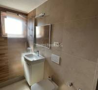 Bathroom in a 2-room apartment with a sink, shower, and toilet.