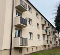 A building with balconies on Svätoplukova Street, Prievidza, offering 2-room apartments.