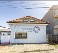 A family house on Podpriehradná in Bratislava-Vrakuňa with an advertisement for a clinic.
