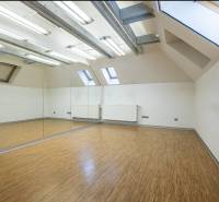 Interior with large mirrors and wood-decor flooring in a family house.