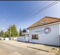 A family house on Podpriehradná Street in Bratislava-Vrakuňa with the clinic's logo.