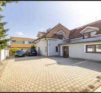 A family house on Podpriehradná Street in Bratislava-Vrakuňa with a spacious paved parking area.