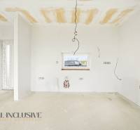 Interior of a cottage during renovation with bare walls and ceiling.