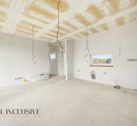 The interior of the cottage with preparations for electrical installations and white walls.