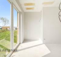 Interior of a cabin with large windows and a view of a grassy area.