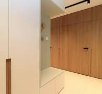 Interior of a 4-room apartment with a built-in wardrobe and flooring with a wood decor.