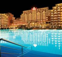 Night panorama of the hotel and pool at Sunny Beach near a one-bedroom apartment.