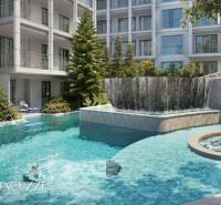 A swimming pool and jacuzzi surrounded by greenery during the construction of apartments in Phuket.