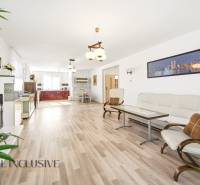 Living room in a family house with a wooden decor floor and light furniture.