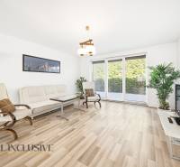 Living room in a family house with light furniture and a wooden decor floor.