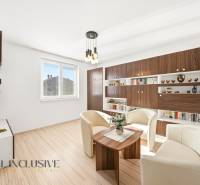 Living room in a family house with white armchairs and a wooden decor floor.