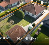 A family house in Kútniky with a well-maintained garden and an access road from a bird's eye view.