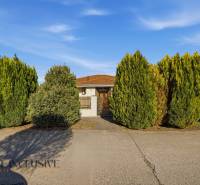 A family house in Kútniky surrounded by trimmed trees, beautiful front garden.