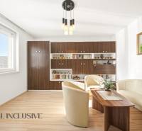 Living room in a family house with a wooden decor floor and comfortable seating.
