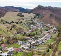 Aerial view of a village surrounded by mountainous landscape in Lietava, on Majer Street, Residential plots.