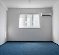 Offices with blue carpet, white walls, and air conditioning.