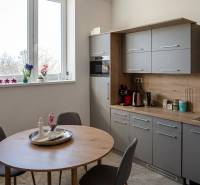 Kitchen corner in offices with a window, wooden decor, and a dining table.