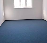 Offices with blue carpet and a window, located on Chovateľská Street in Trnava.