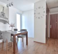 Dining area in a 3-room apartment with Eiffel Tower decor and wooden decor flooring.